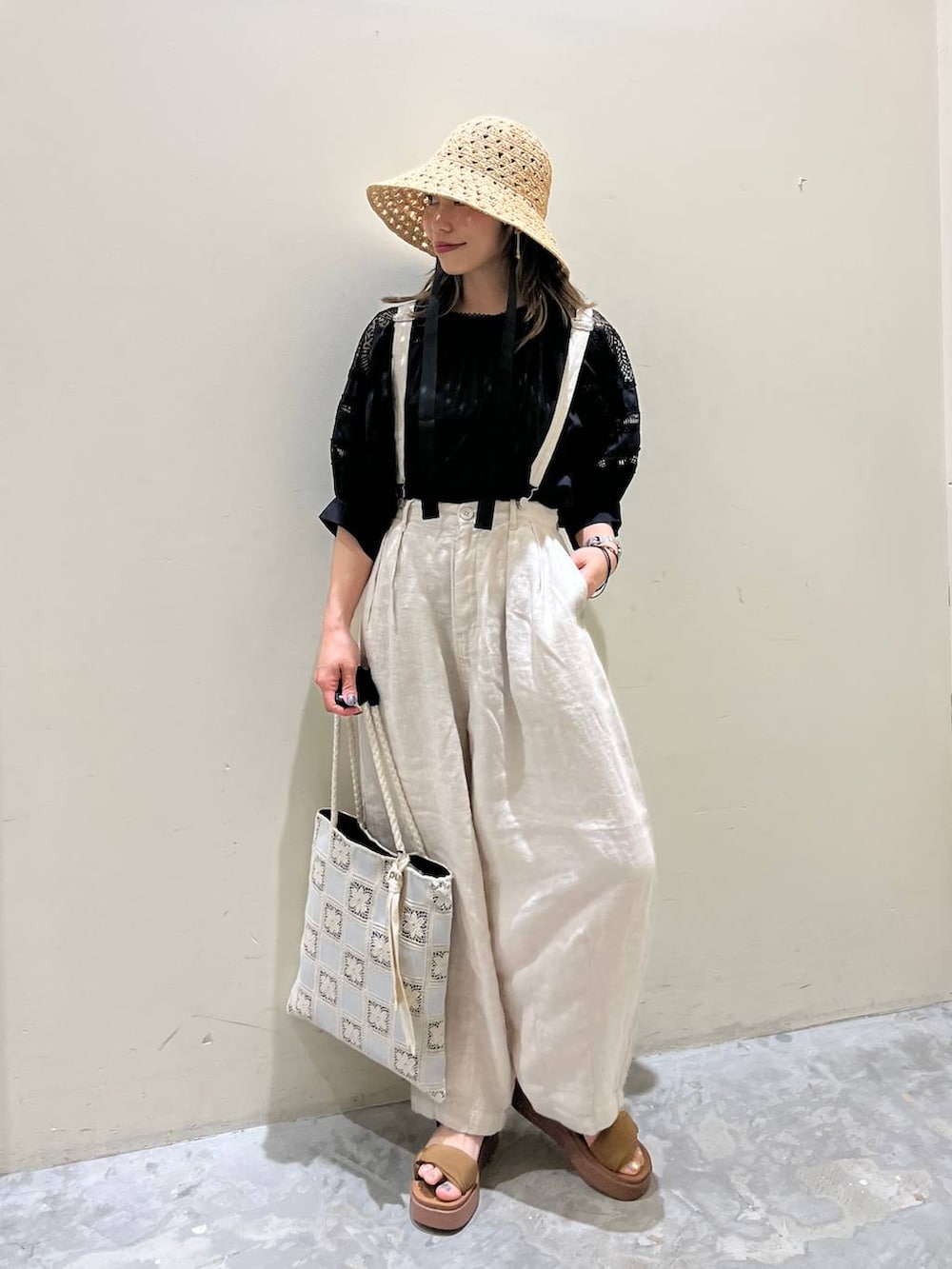 イエロー系のサンダル、ベージュ系のその他パンツ、ホワイト系のトートバッグを着用したレディースの春コーディネートの3枚目の写真