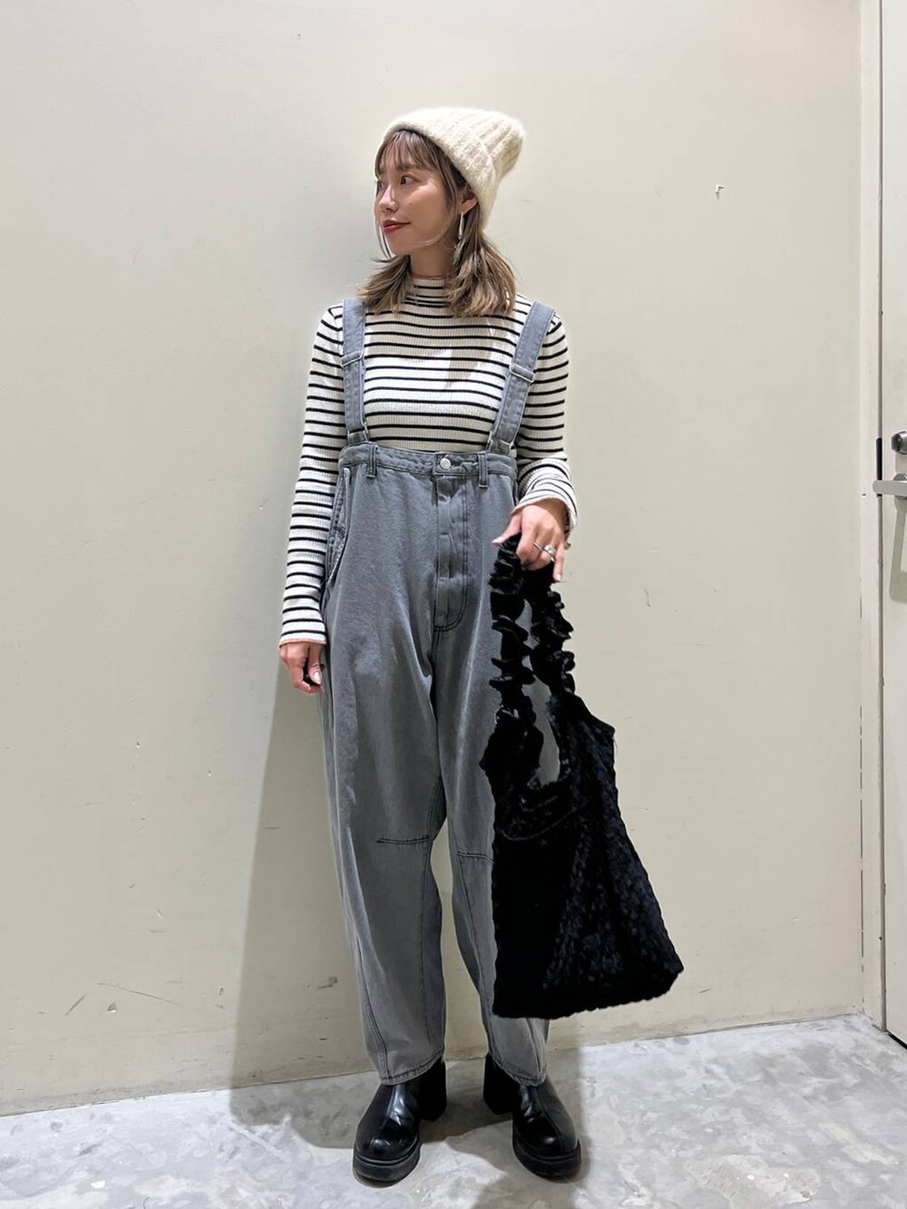 ブラック系のトートバッグ、その他のその他パンツ、ホワイト系のニット/セーターを着用したレディースの冬コーディネートの3枚目の写真