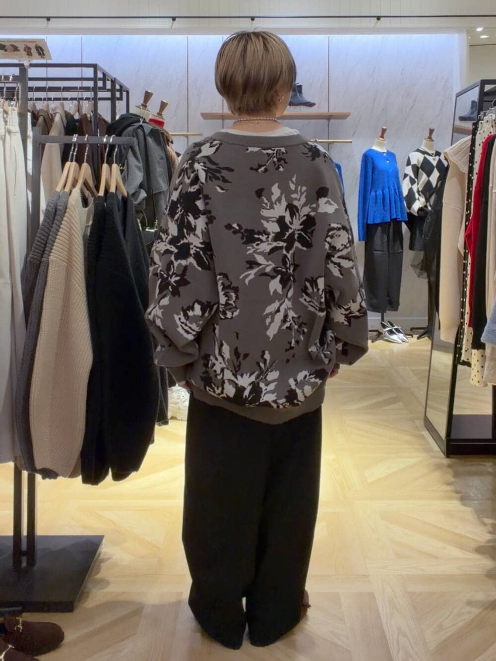 グレー系のカーディガン/ボレロ、グレー系のその他パンツ、ブラウン系のモカシン/デッキシューズを着用したレディースの秋コーディネートの3枚目の写真