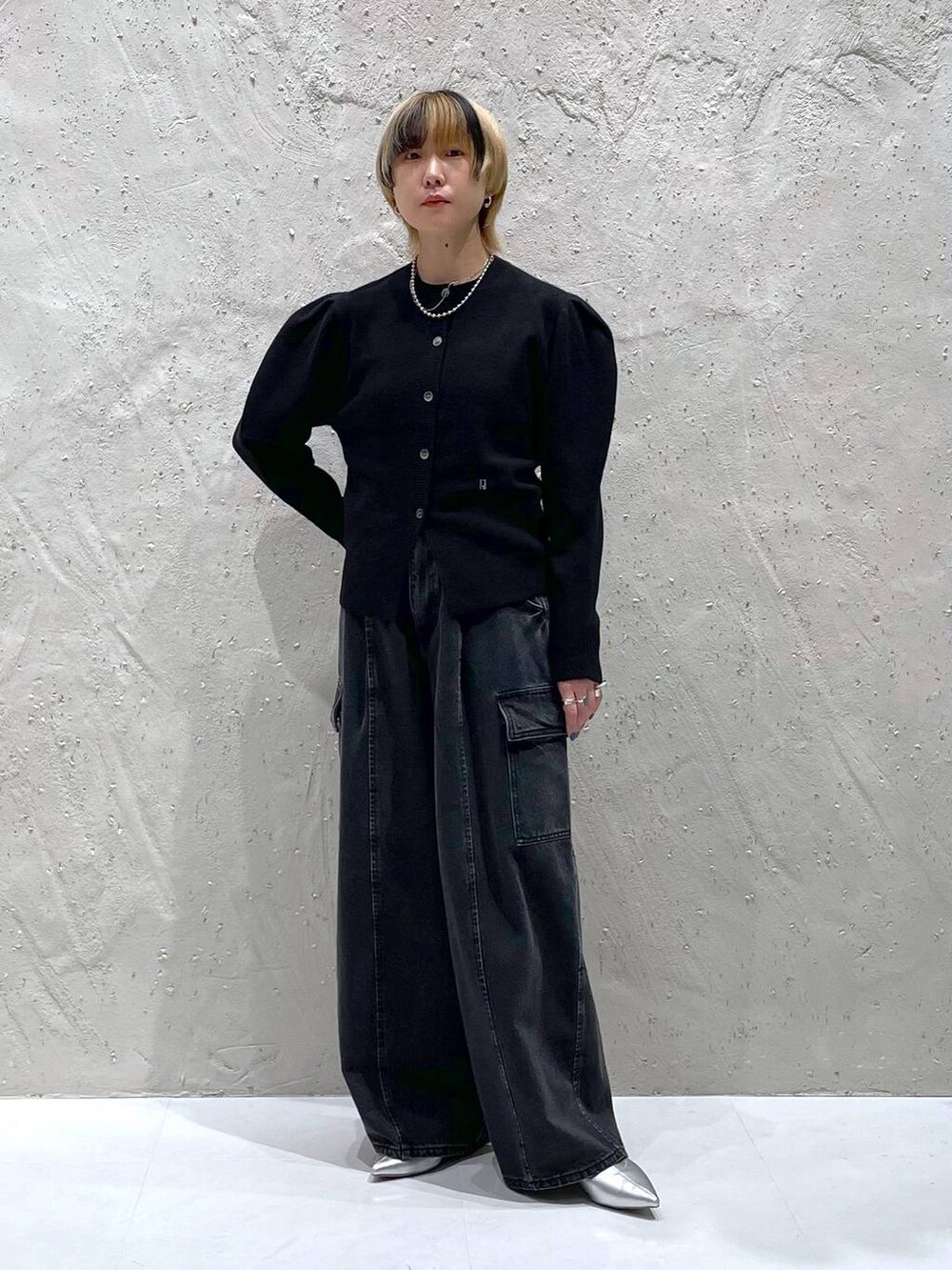 ブラック系のデニムパンツ、シルバー系のブーツ、ブラック系のカーディガン/ボレロを着用したレディースの秋コーディネートの5枚目の写真
