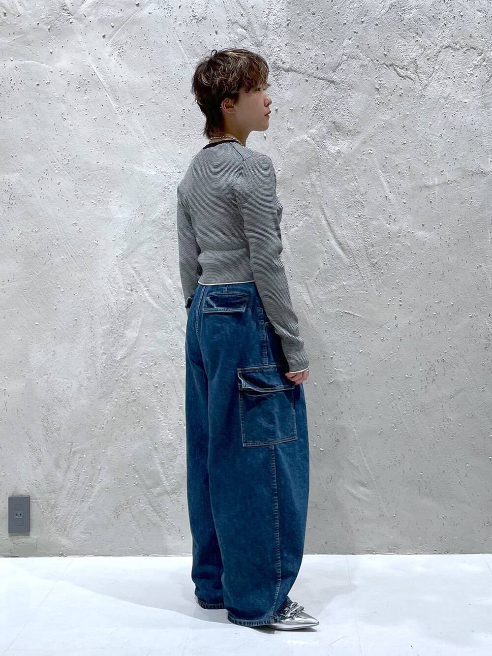 ブルー系のデニムパンツ、シルバー系のパンプス、その他のニット/セーターを着用したレディースの夏コーディネートの4枚目の写真