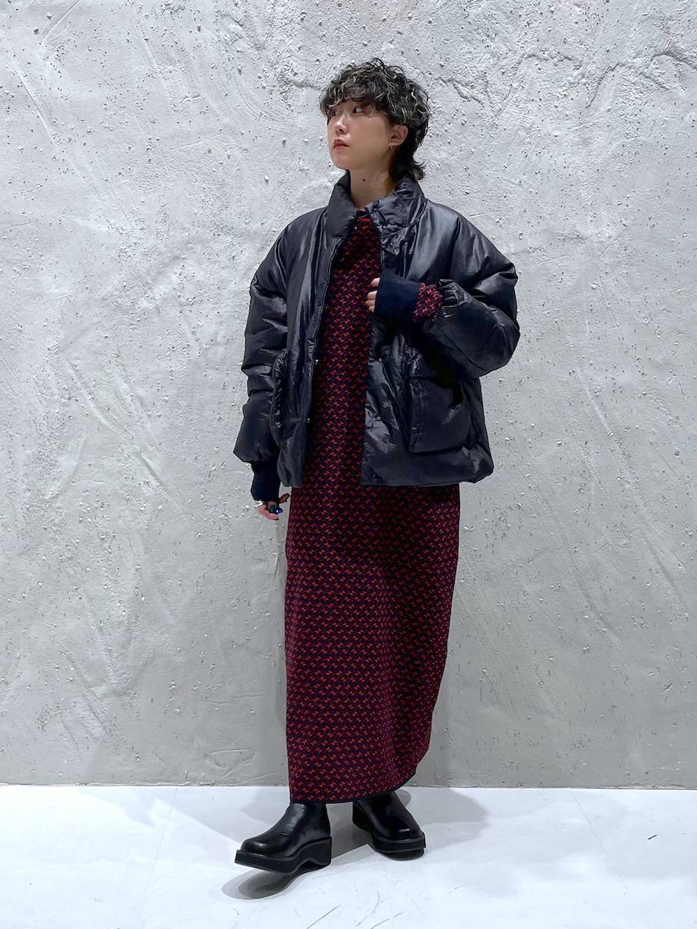 ブラック系のブーツ、ブラック系のダウンジャケット/コート、レッド系のワンピースを着用したレディースの秋コーディネートの5枚目の写真