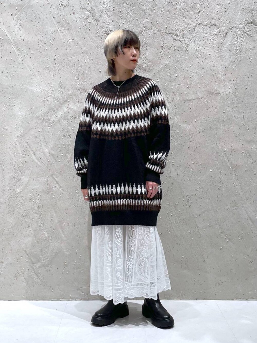 ホワイト系のスカート、ブラック系のブーツ、ブラック系のワンピースを着用したレディースの冬コーディネートの5枚目の写真