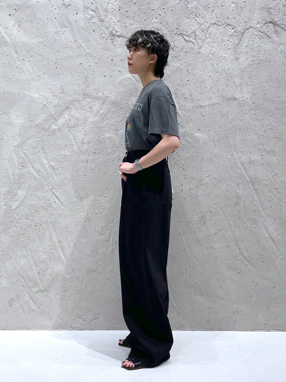 グレー系のTシャツ/カットソー、ブラック系のデニムパンツ、ブラック系のサンダルを着用したレディースの夏コーディネートの2枚目の写真