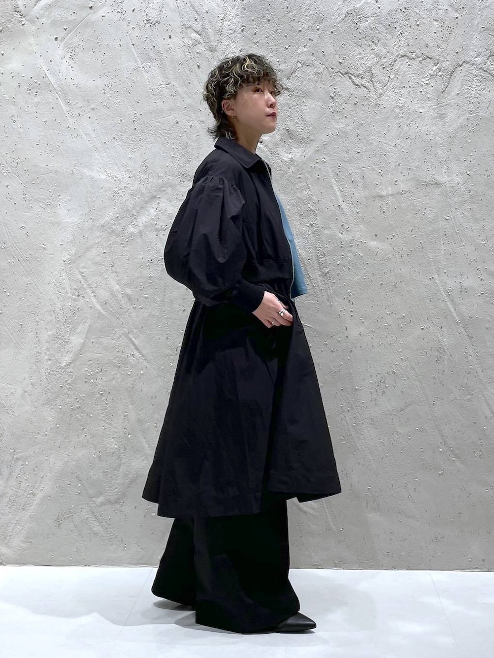 ブラック系のブルゾン、ブラック系のブーツ、ブルー系のTシャツ/カットソーを着用したレディースの冬コーディネートの4枚目の写真