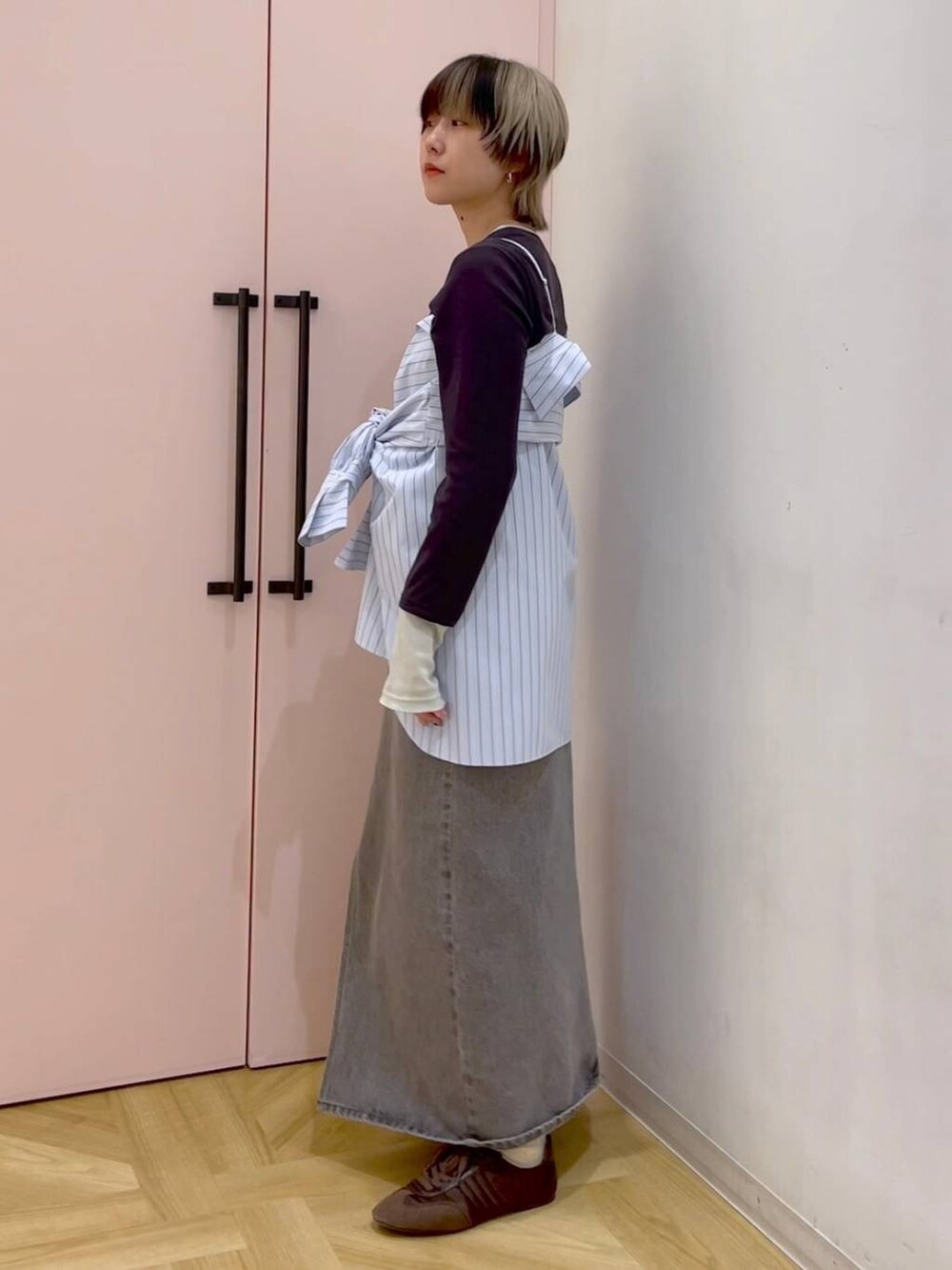 ブルー系のシャツ/ブラウス、グレー系のTシャツ/カットソー、ブラウン系のスニーカーを着用したレディースの冬コーディネートの2枚目の写真