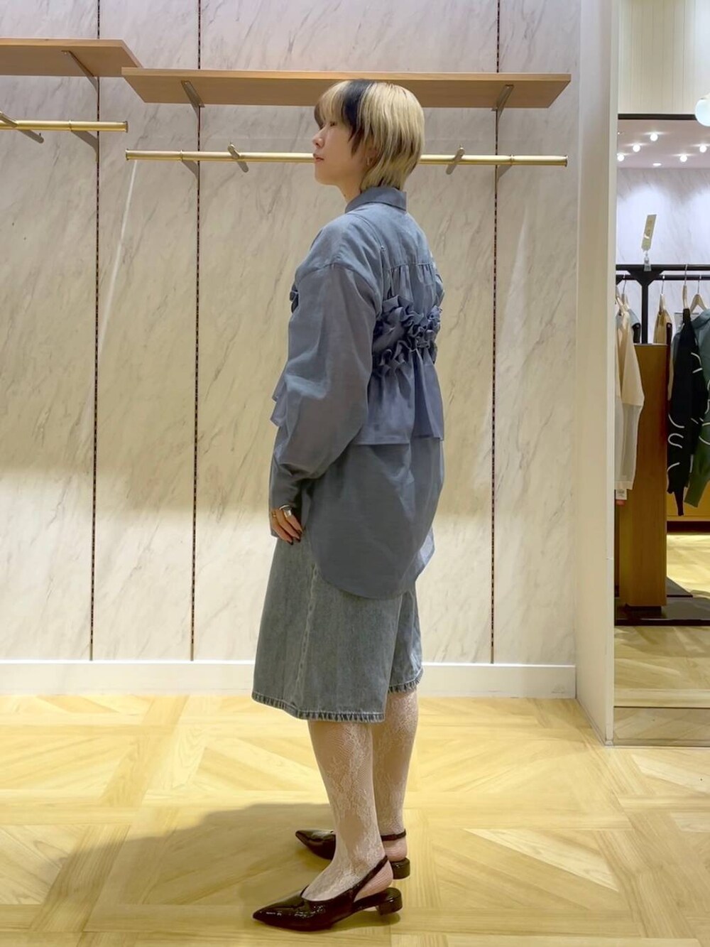 ブルー系のシャツ/ブラウス、ブルー系のキャミソール、ブラック系のショルダーバッグを着用したレディースの春コーディネートの2枚目の写真