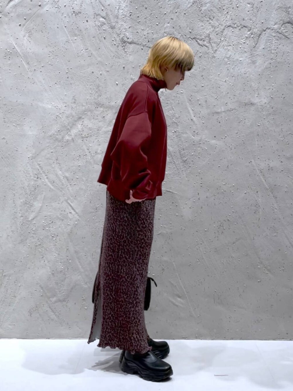 ブラック系のブーツ、ブラック系のショルダーバッグ、その他のスカートを着用したレディースの秋コーディネートの4枚目の写真