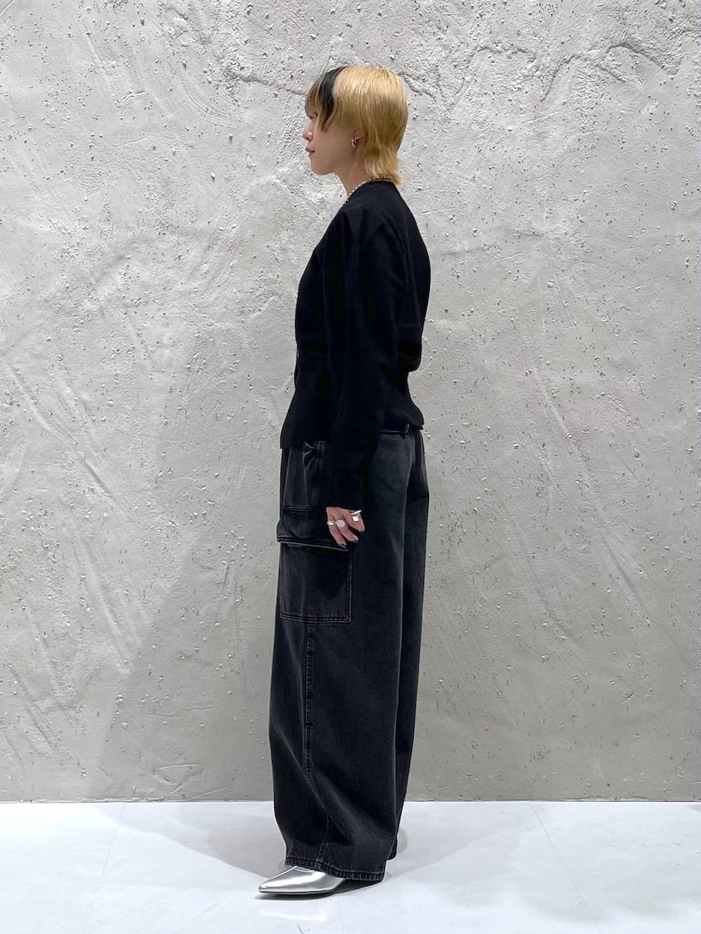 ブラック系のデニムパンツ、シルバー系のブーツ、ブラック系のカーディガン/ボレロを着用したレディースの秋コーディネートの2枚目の写真