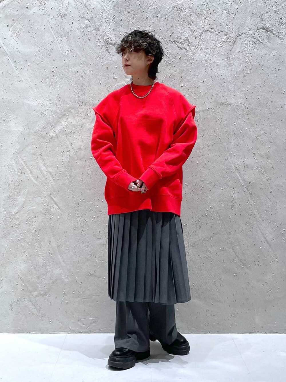 グレー系のその他パンツ、ブラック系のブーツ、レッド系のスウェットを着用したレディースの冬コーディネートの5枚目の写真