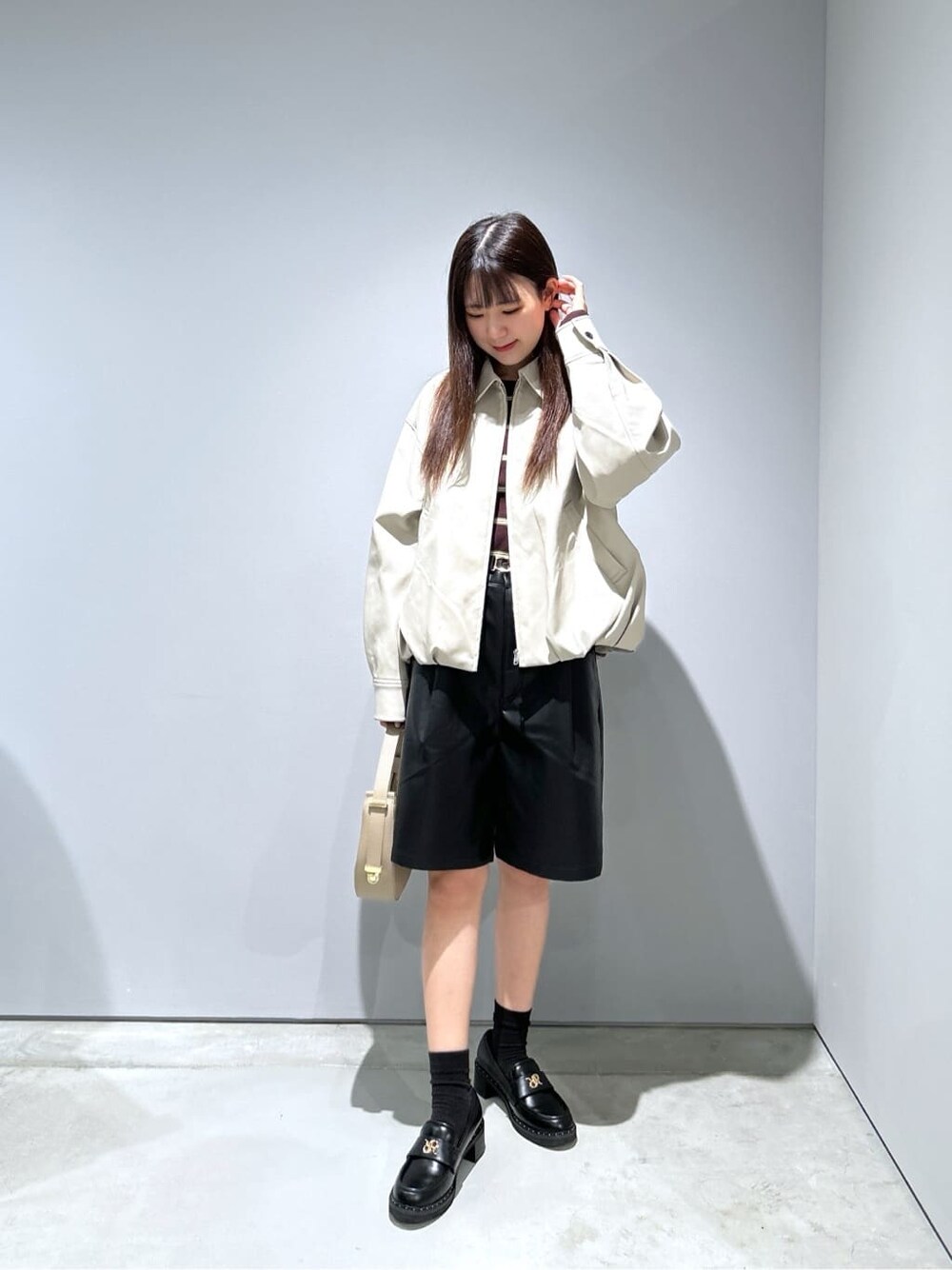 ベージュ系のブルゾン、ブラック系のその他パンツ、ベージュ系のショルダーバッグを着用したレディースの秋コーディネートの4枚目の写真