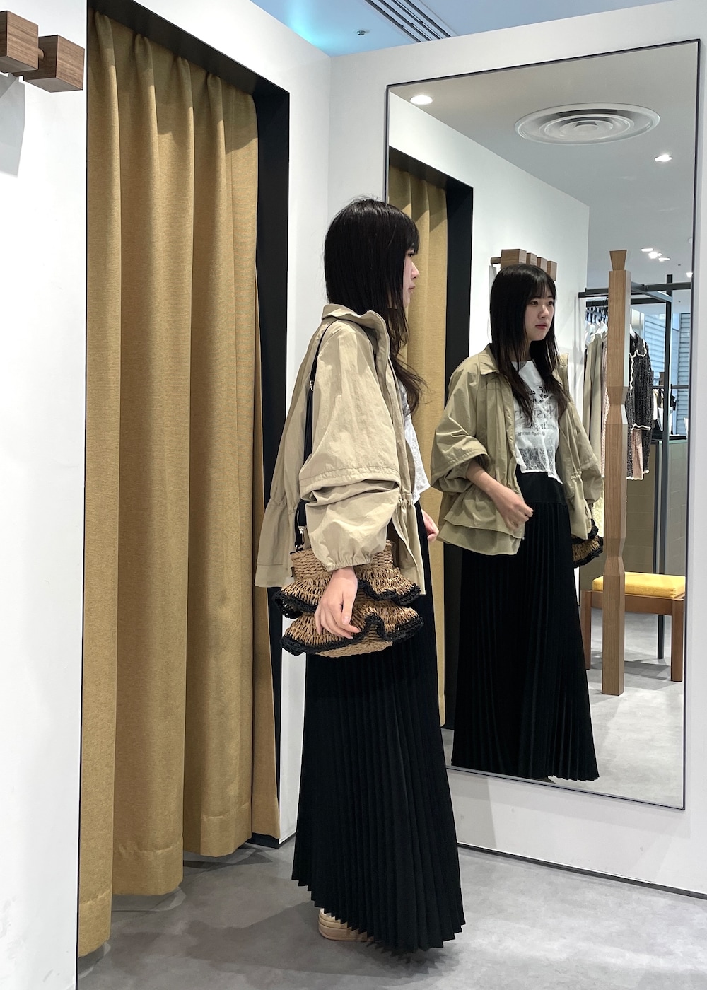 ホワイト系のTシャツ/カットソー、ホワイト系のシャツ/ブラウス、ブラック系のスカートを着用したレディースの春コーディネートの4枚目の写真