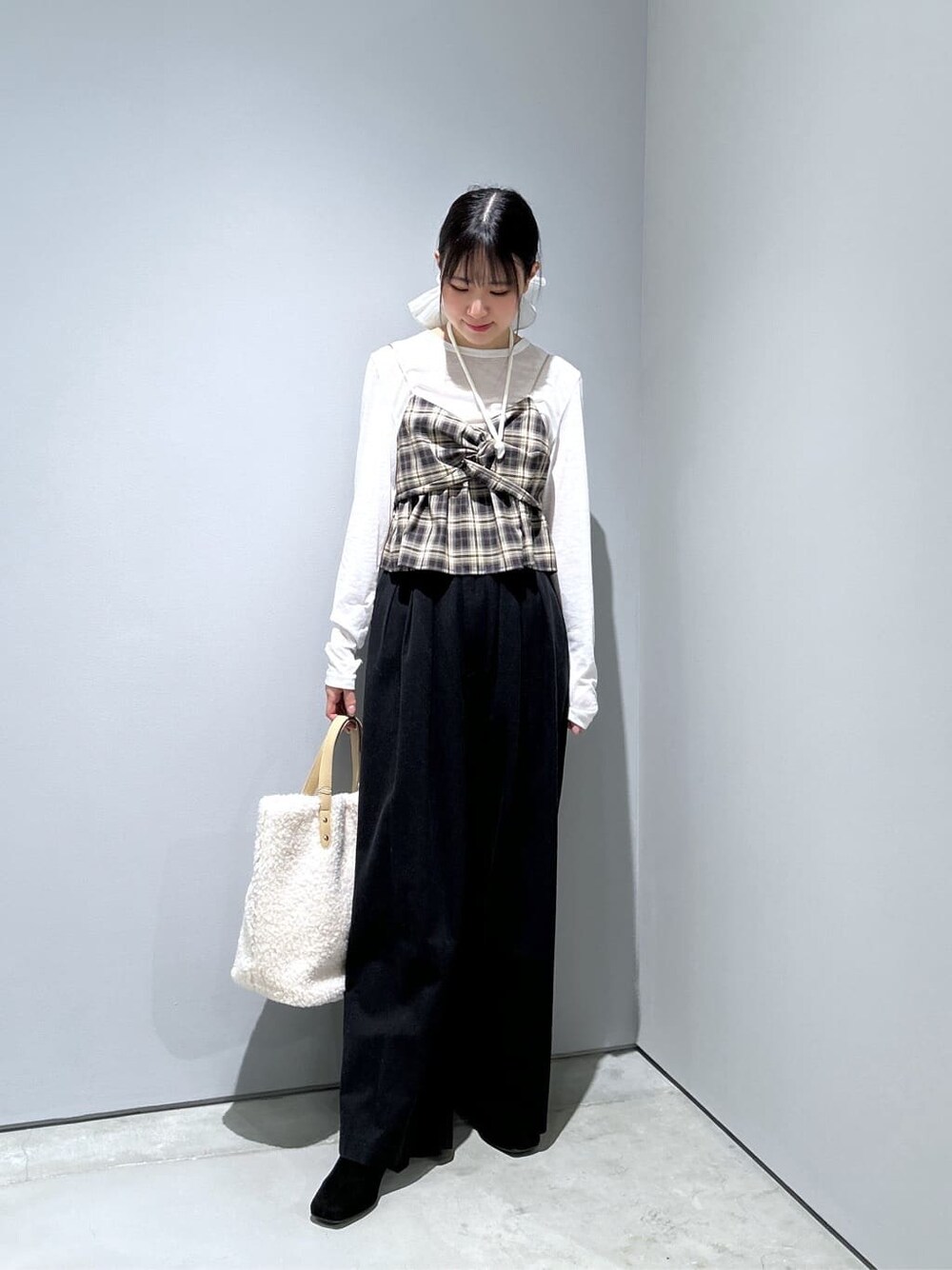 ベージュ系のタンクトップ、ホワイト系のTシャツ/カットソー、ブラック系のその他パンツを着用したレディースの冬コーディネートの4枚目の写真