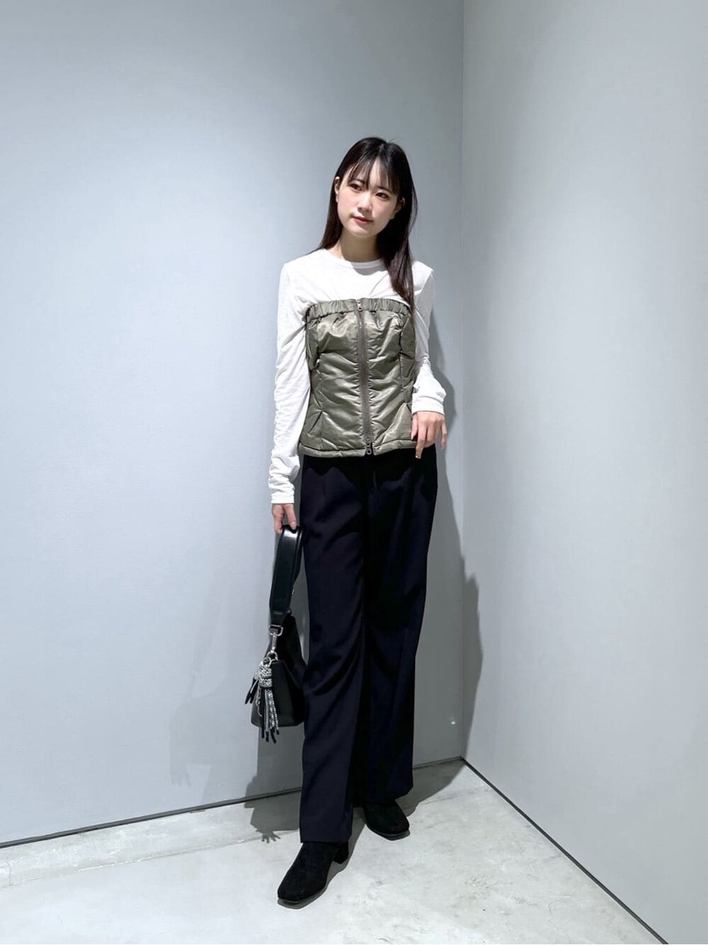 グリーン系のその他アウター、ホワイト系のTシャツ/カットソー、ブラック系のその他パンツを着用したレディースの冬コーディネートの3枚目の写真
