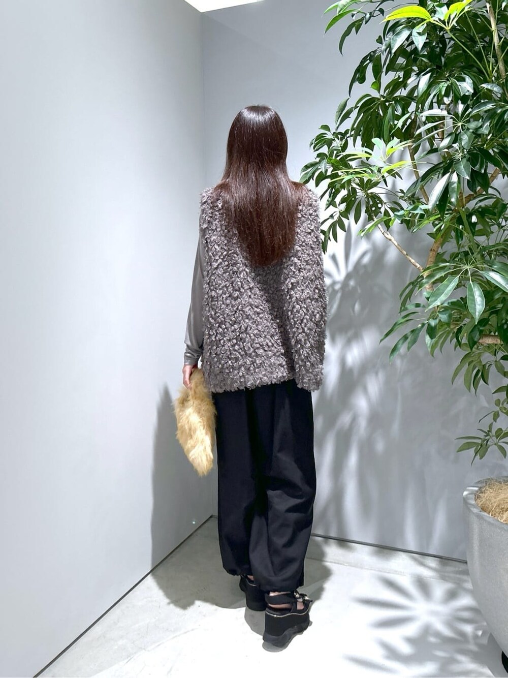 グレー系のTシャツ/カットソー、ブラック系のその他パンツ、ベージュ系のハンドバッグを着用したレディースの秋コーディネートの5枚目の写真