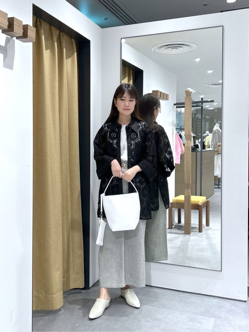 ブラック系のシャツ/ブラウス、ホワイト系のタンクトップ、グレー系のスカートを着用したレディースの春コーディネートの2枚目の写真