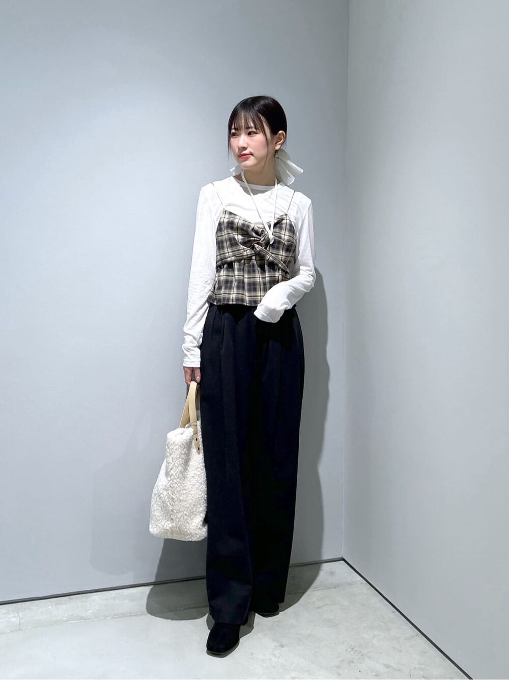 ベージュ系のタンクトップ、ホワイト系のTシャツ/カットソー、ブラック系のその他パンツを着用したレディースの冬コーディネートの3枚目の写真