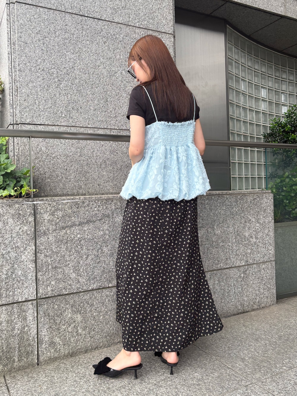 ブルー系のキャミソール、ブラック系のスカートを着用したレディースの夏コーディネートの2枚目の写真
