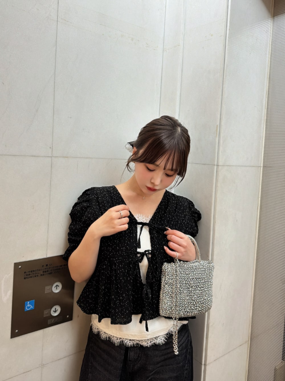 ブラック系のデニムパンツ、ブラック系のシャツ/ブラウス、ホワイト系のキャミソールを着用したレディースの夏コーディネートの3枚目の写真