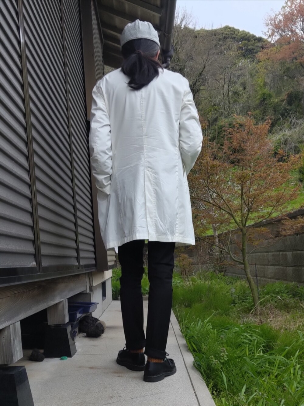 ブラック系のモカシン/デッキシューズ、ブラック系のデニムパンツ、ブルー系のショルダーバッグを着用したメンズの春コーディネートの2枚目の写真