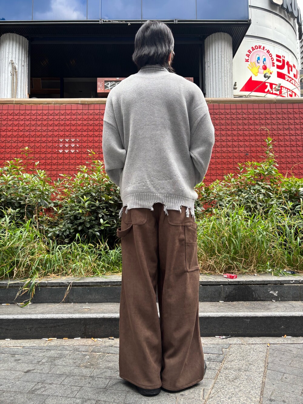 グレー系のトップス、ブラウン系のパンツを着用したメンズの夏コーディネートの3枚目の写真