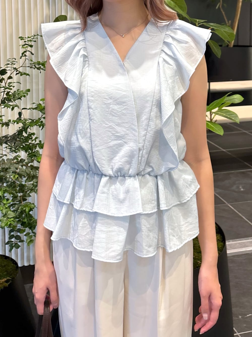 ブルー系のシャツ/ブラウス、ホワイト系のその他パンツ、ブラウン系のボストンバッグを着用したレディースの夏コーディネートの9枚目の写真