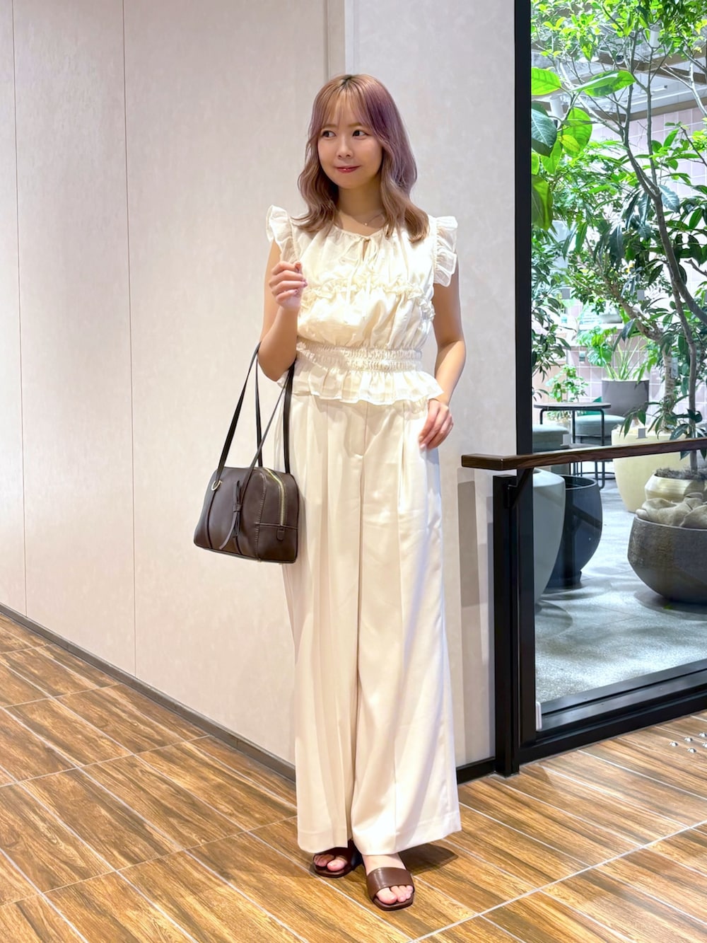 ホワイト系のシャツ/ブラウス、ホワイト系のその他パンツ、ブラウン系のボストンバッグを着用したレディースの夏コーディネートの6枚目の写真