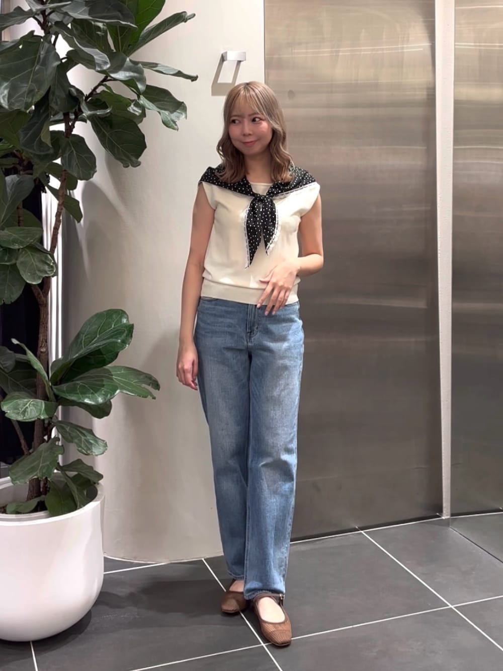 ホワイト系のニット/セーター、ブルー系のデニムパンツ、ブラウン系のサンダルを着用したレディースの夏コーディネートの3枚目の写真