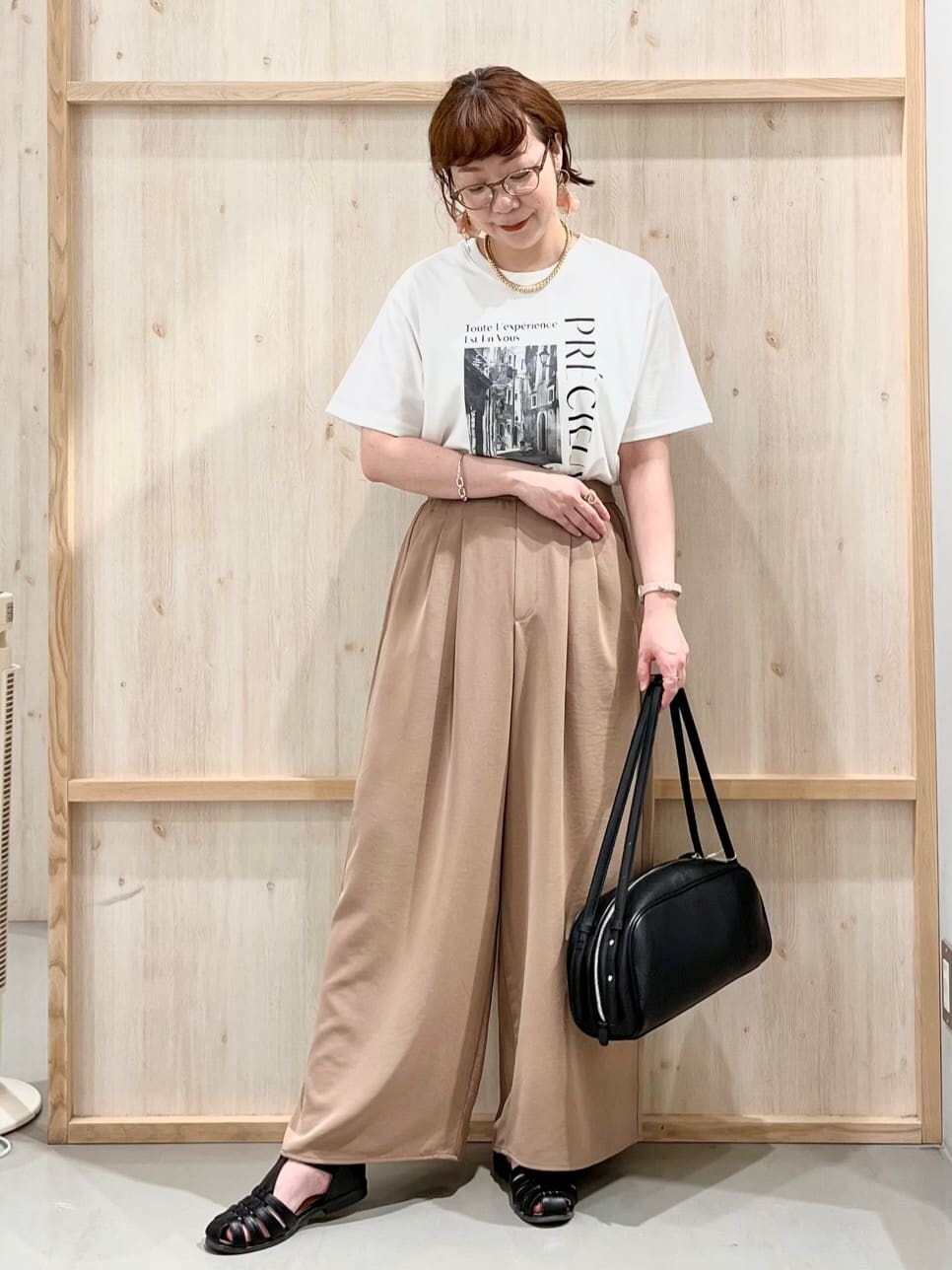 ホワイト系のTシャツ/カットソー、ベージュ系のその他パンツ、ブラック系のトートバッグを着用したレディースの夏コーディネートの3枚目の写真