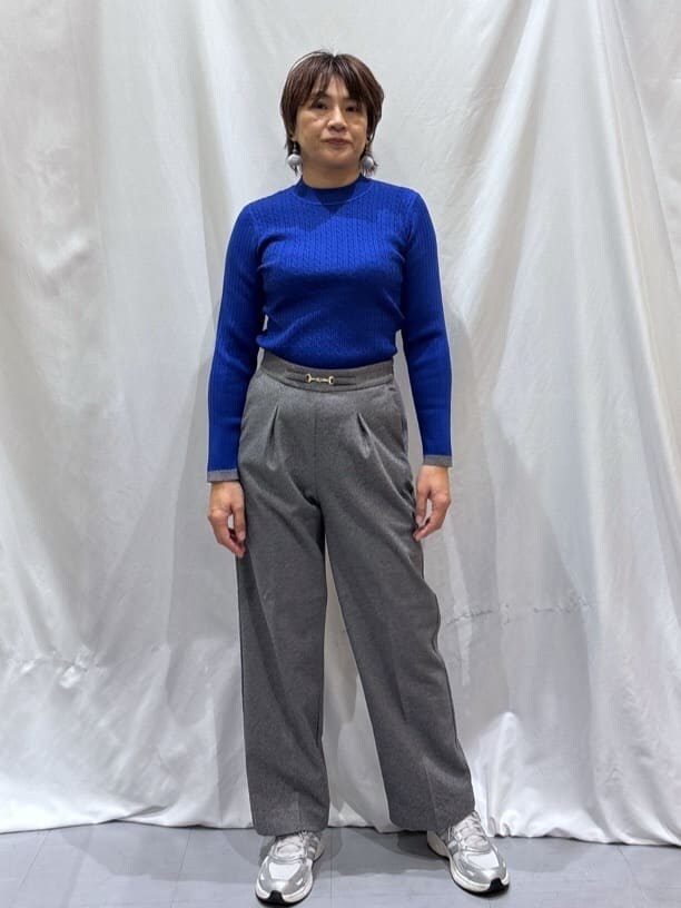 ベージュ系のチェスターコート、ブルー系のニット/セーター、グレー系のその他パンツを着用したレディースの冬コーディネートの5枚目の写真