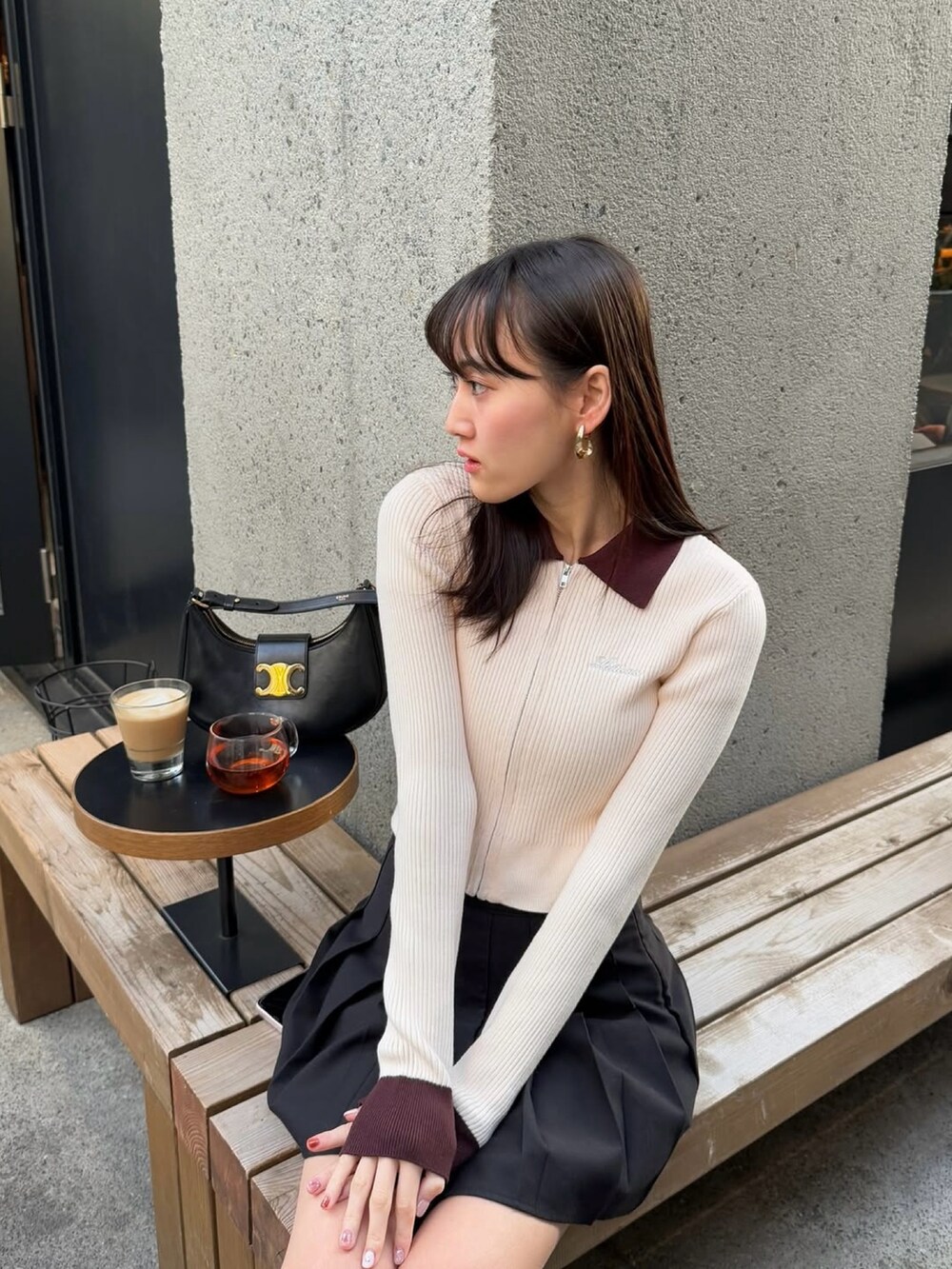 ベージュ系のトップスを着用したレディースの春コーディネートの2枚目の写真