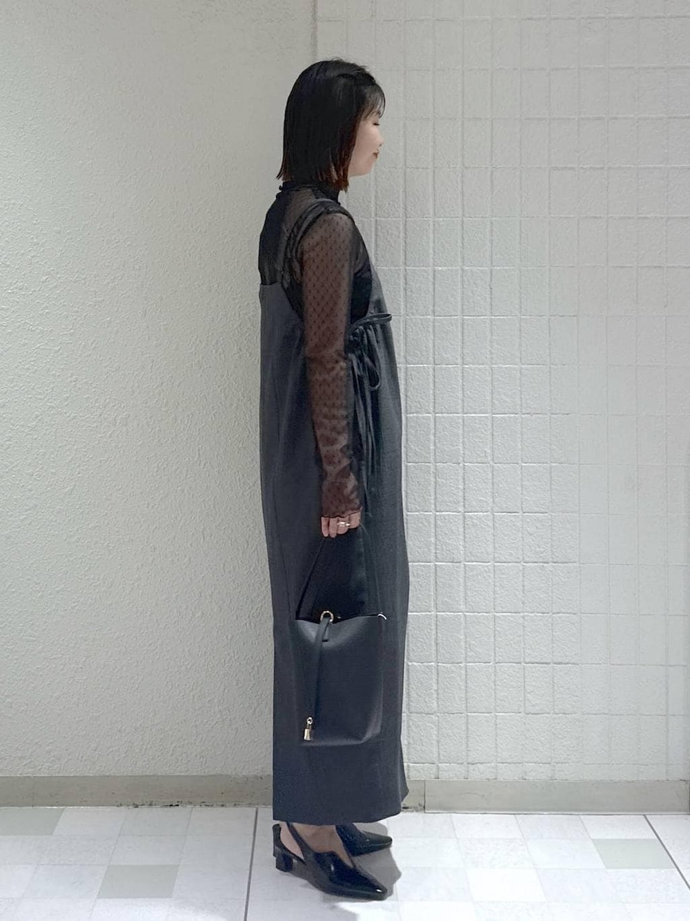 ブラック系のTシャツ/カットソー、グレー系のワンピース、ブラック系のパンプスを着用したレディースの春コーディネートの3枚目の写真