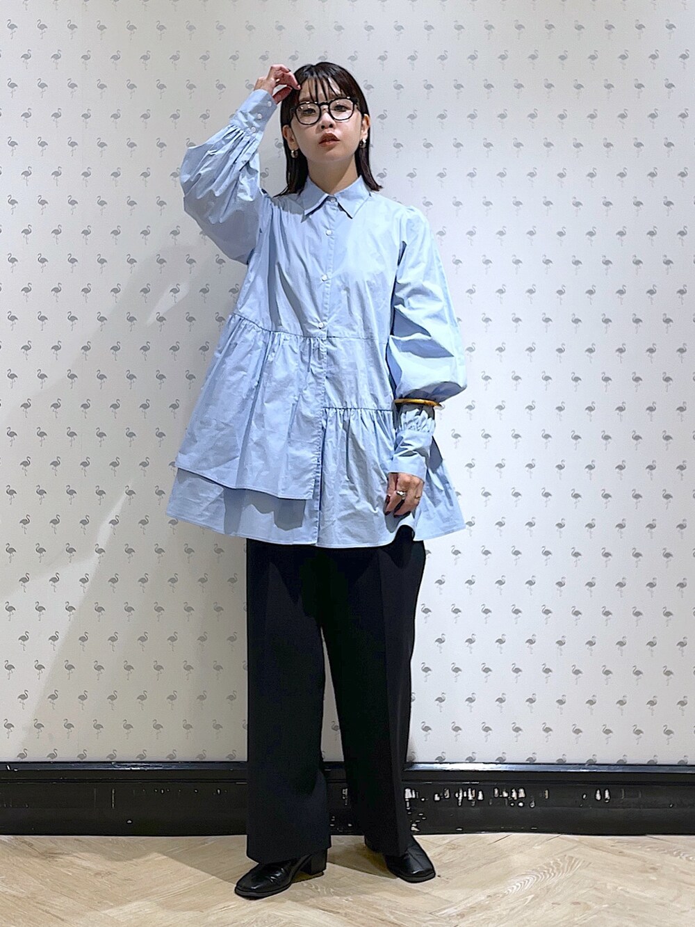 ブラック系のスラックス、ブルー系のシャツ/ブラウスを着用したレディースの秋コーディネートの2枚目の写真