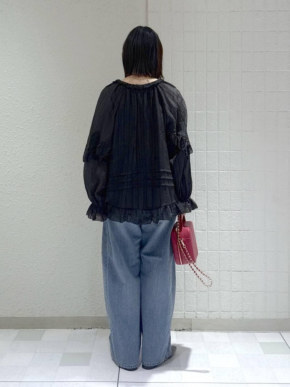 ブルー系のデニムパンツ、ブラック系のシャツ/ブラウス、ブラック系のパンプスを着用したレディースの春コーディネートの3枚目の写真