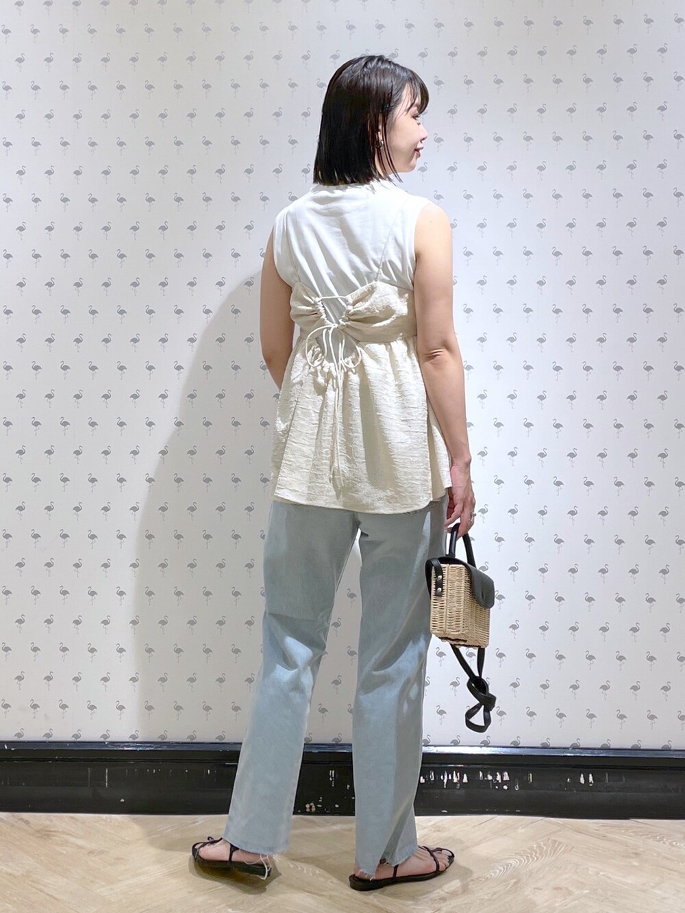 ホワイト系のTシャツ/カットソー、ブルー系のデニムパンツ、ブラック系のサンダルを着用したレディースの夏コーディネートの2枚目の写真