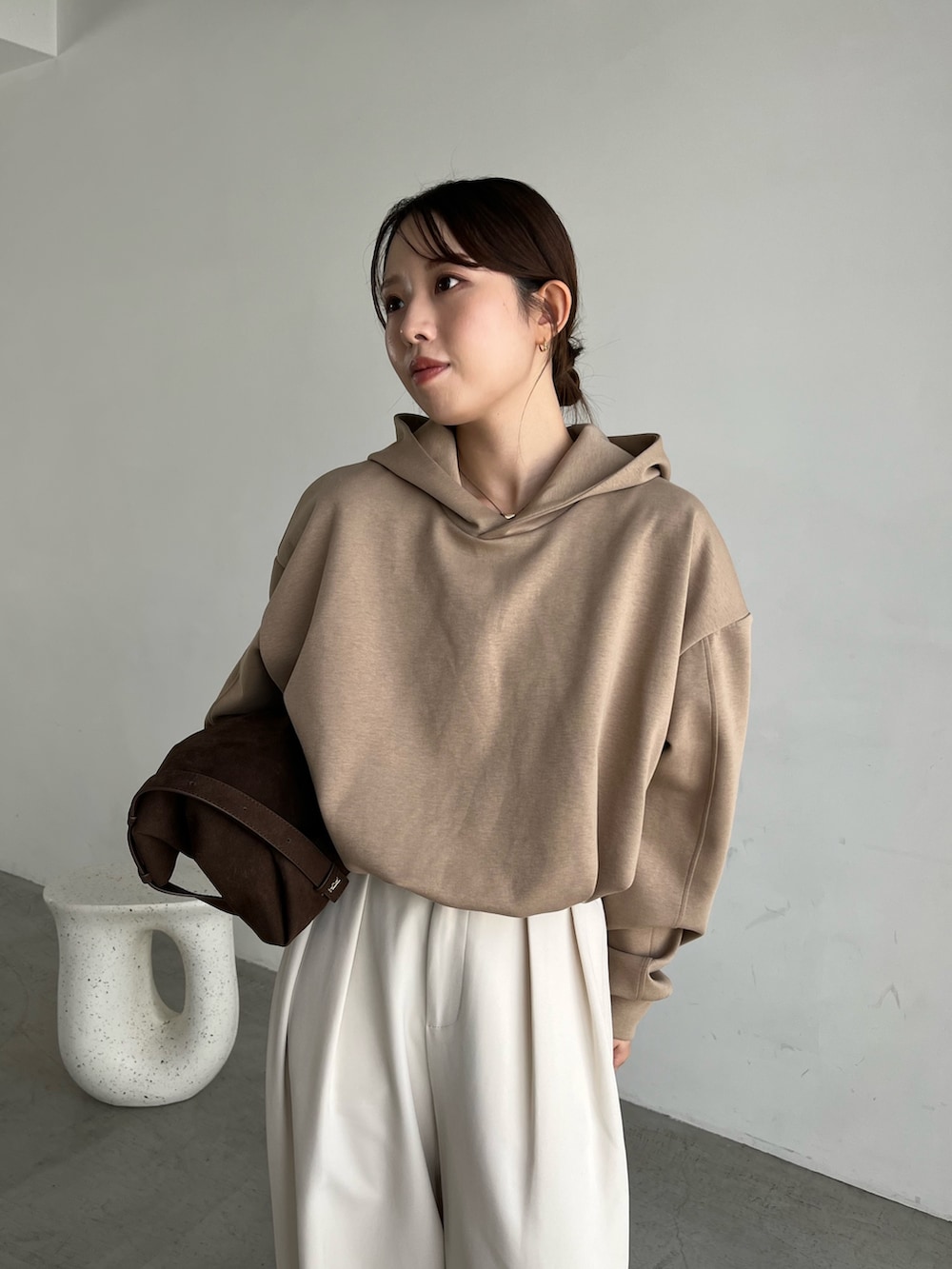 ベージュ系のTシャツ/カットソー、ブラック系のパンプス、ブラウン系のトートバッグを着用したレディースの秋コーディネートの2枚目の写真