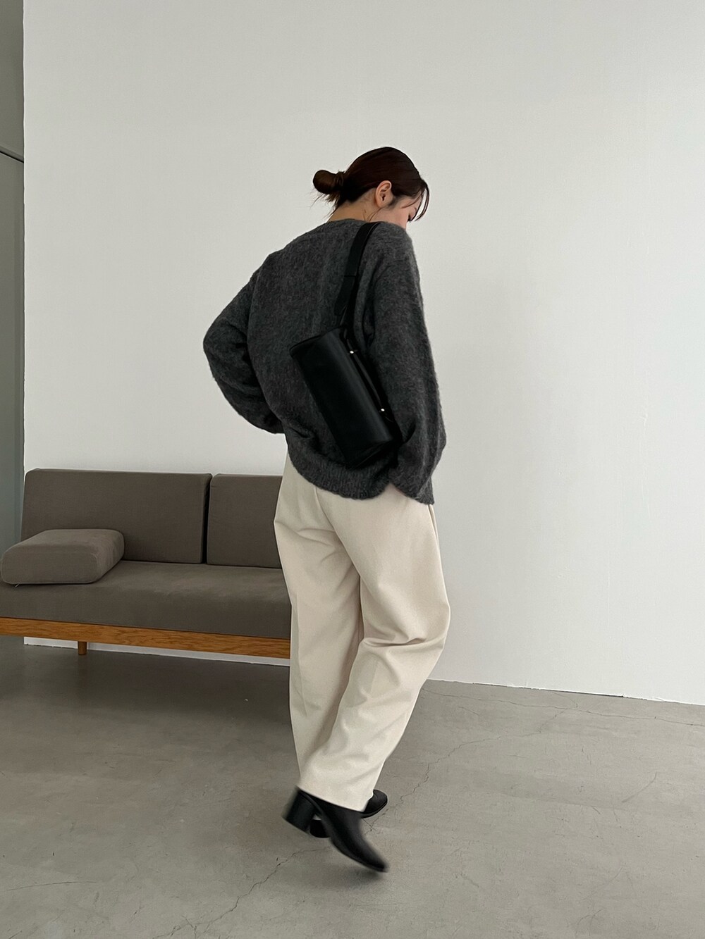 ホワイト系のTシャツ/カットソー、グレー系のカーディガン/ボレロ、ブラック系のショルダーバッグを着用したレディースの冬コーディネートの4枚目の写真