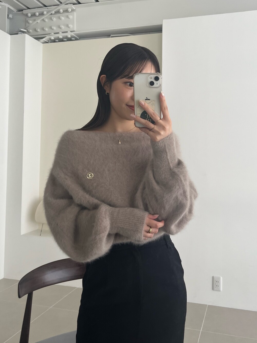 ブラウン系のニット/セーター、ブラック系のスカート、ブラック系のパンプスを着用したレディースの夏コーディネートの5枚目の写真