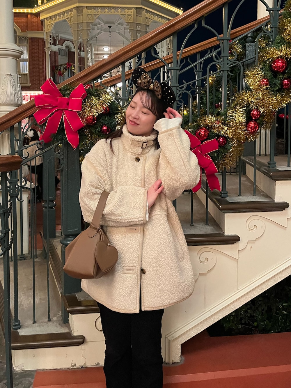 ホワイト系のその他アウター、ブラック系のその他パンツ、イエロー系のハンドバッグを着用したレディースの冬コーディネートの5枚目の写真