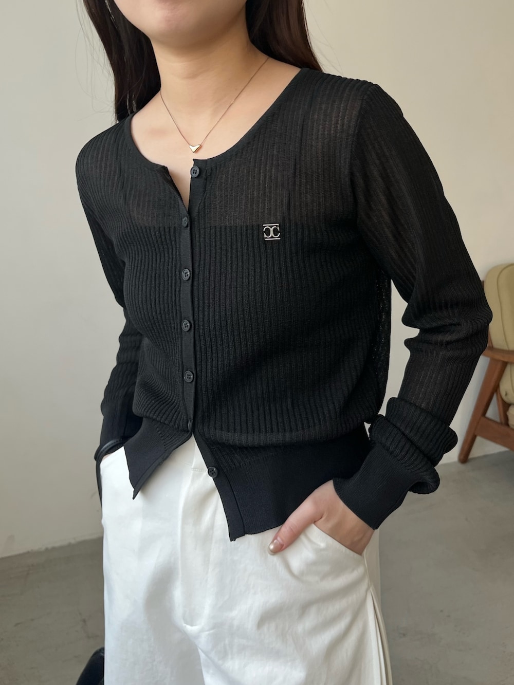 ブラック系のカーディガン/ボレロ、ホワイト系のその他パンツ、ブラック系のパンプスを着用したレディースの春コーディネートの6枚目の写真