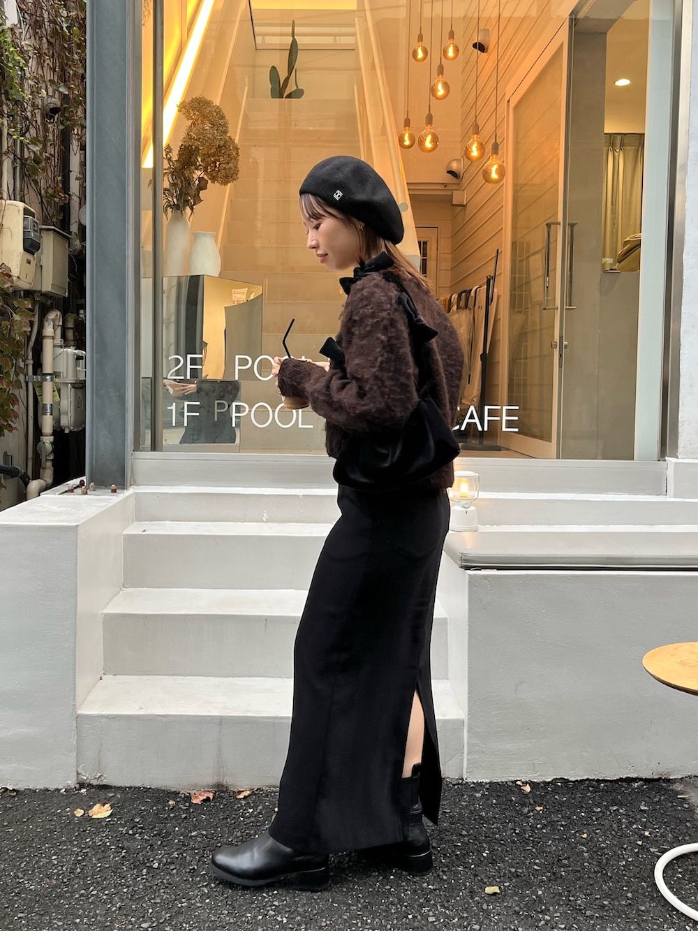 ブラウン系のカーディガン/ボレロ、ブラック系のスカート、ブラック系のパンプスを着用したレディースの秋コーディネートの5枚目の写真