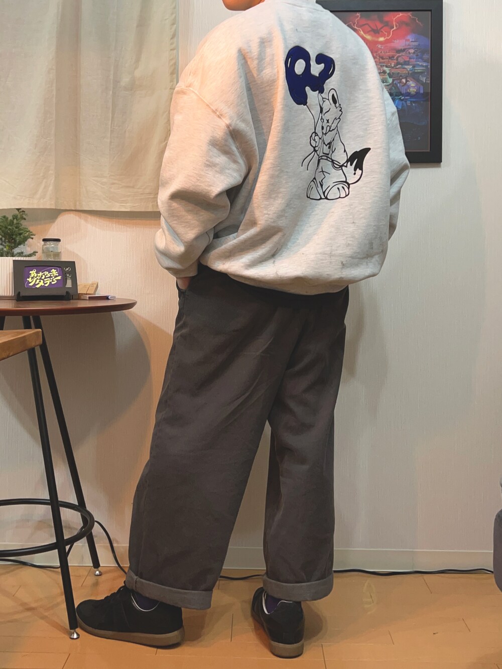 ブラック系のスニーカー、ブラック系のデニムパンツ、グレー系のスウェットを着用したメンズの冬コーディネートの2枚目の写真
