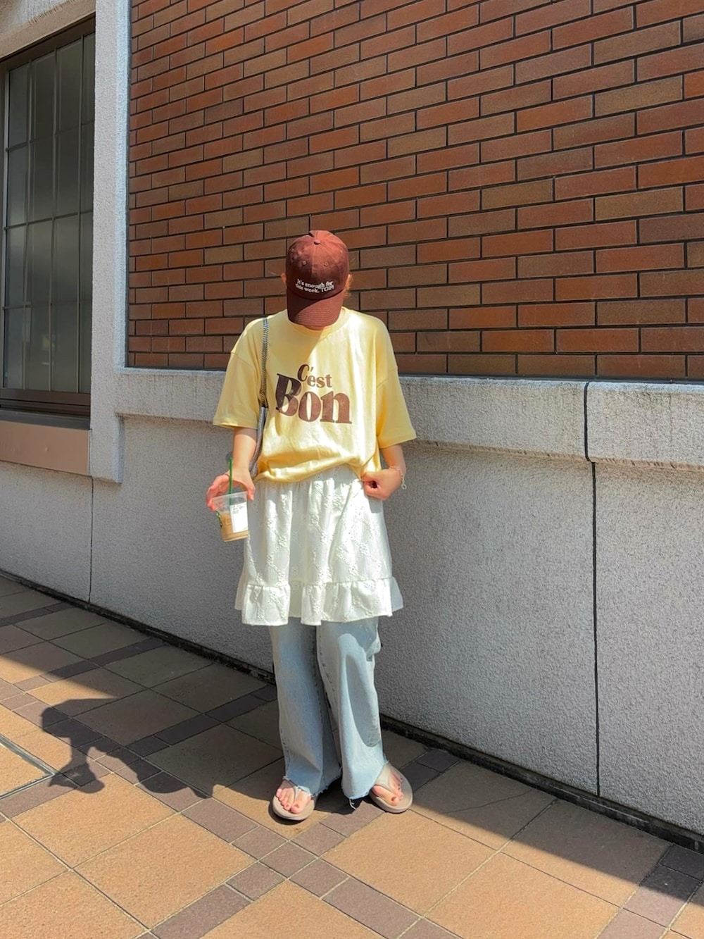 ホワイト系のワンピース、イエロー系のTシャツ/カットソー、ブルー系のデニムパンツを着用したレディースの夏コーディネートの2枚目の写真