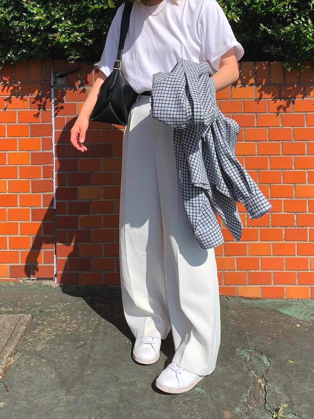 ホワイト系のTシャツ/カットソー、ホワイト系のスラックス、ホワイト系のキャップを着用したレディースの春コーディネートの2枚目の写真