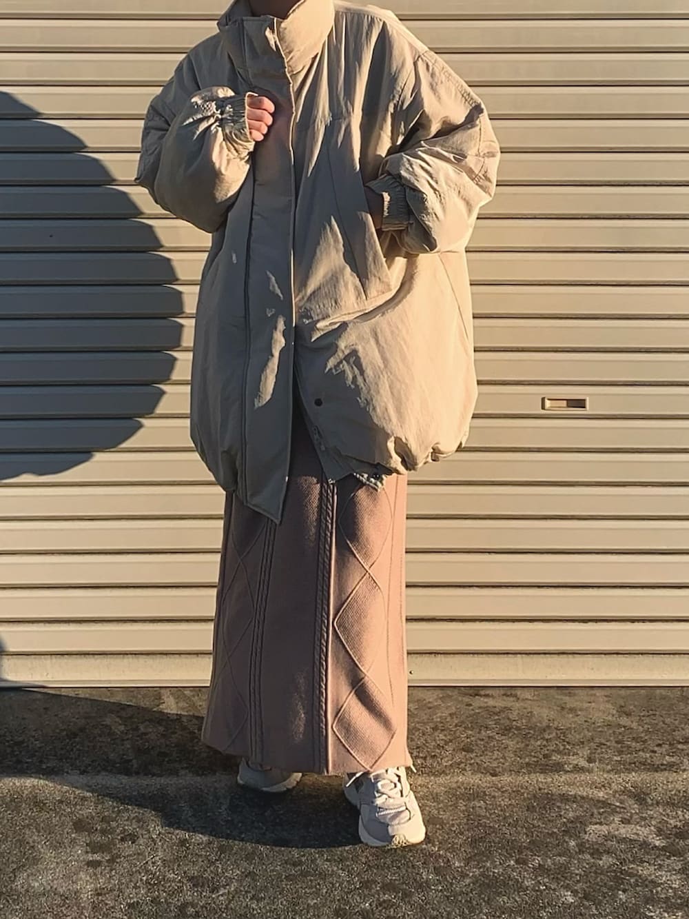 ベージュ系のスカート、ホワイト系のテーラードジャケットを着用したレディースの冬コーディネートの2枚目の写真