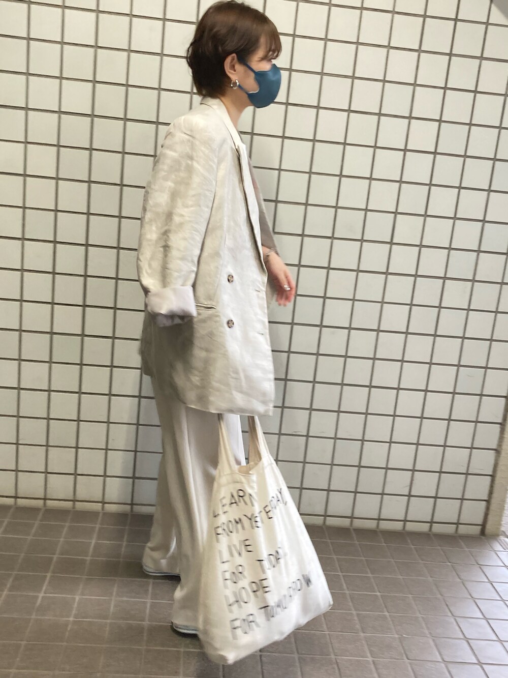 ホワイト系のTシャツ/カットソー、ホワイト系のテーラードジャケット、ホワイト系のスニーカーを着用したレディースの春コーディネートの3枚目の写真