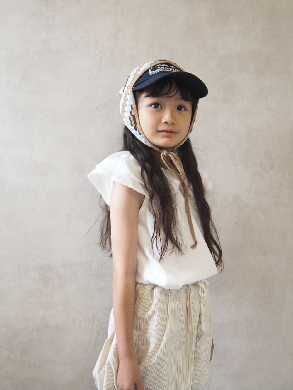 ホワイト系のTシャツ/カットソー、ベージュ系のその他パンツ、シルバー系のショルダーバッグを着用したキッズの夏コーディネートの5枚目の写真