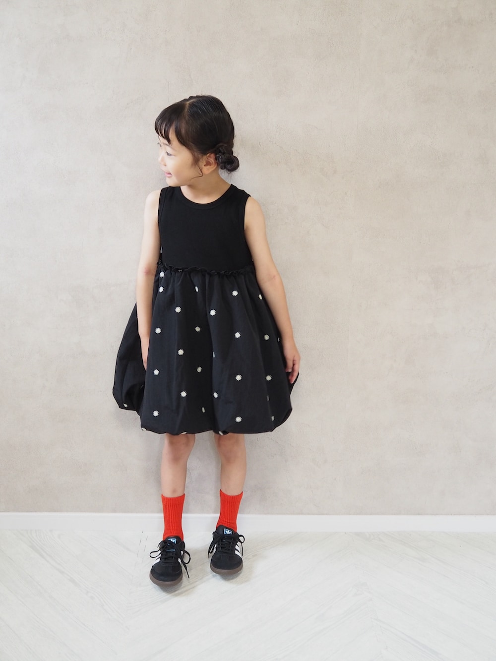 ブラック系のスニーカー、ブラック系のワンピース、レッド系のソックス/靴下を着用したキッズの夏コーディネートの2枚目の写真