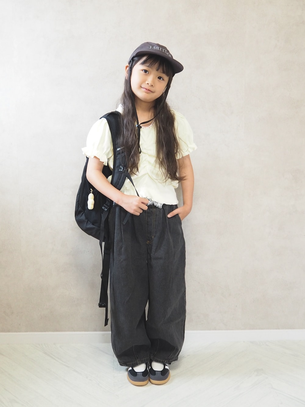 ブラック系のデニムパンツ、ブラック系のスニーカー、ホワイト系のTシャツ/カットソーを着用したキッズの夏コーディネートの2枚目の写真