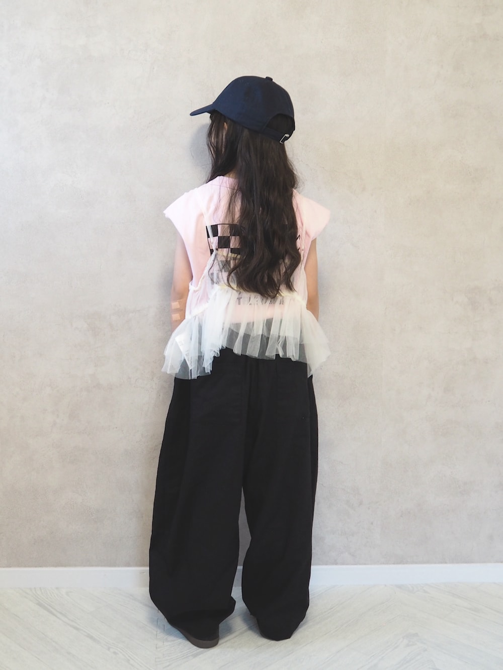 ブラック系のスニーカー、ピンク系のTシャツ/カットソー、ブラック系のその他パンツを着用したキッズの春コーディネートの3枚目の写真